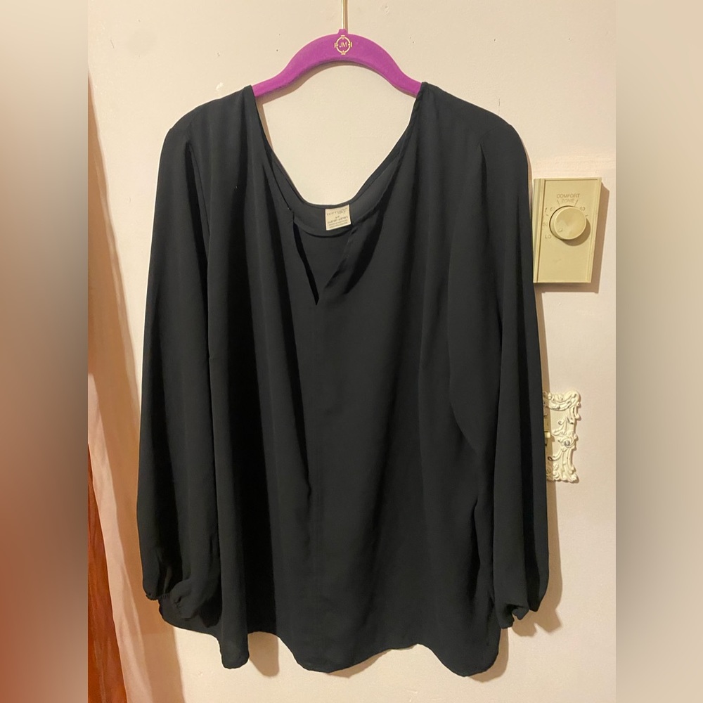 Black, casual or formal blouse, fitted details at wrist, cut out on the front